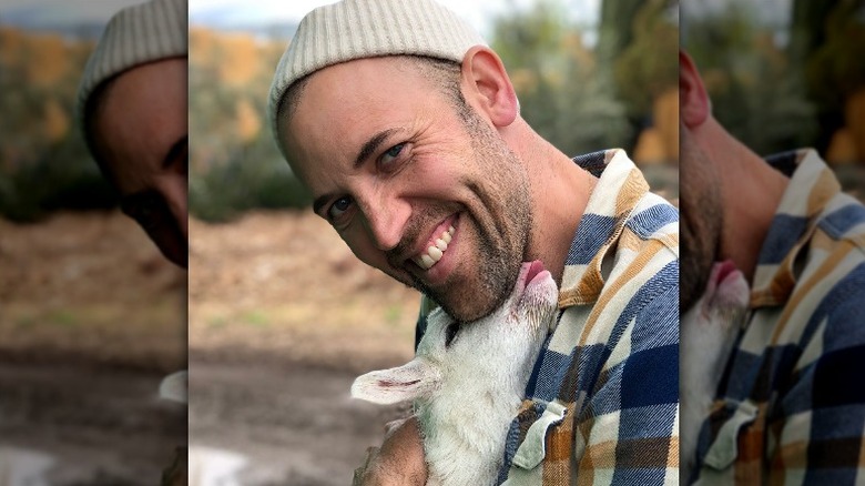 Ryland Engelhart smiling with goat