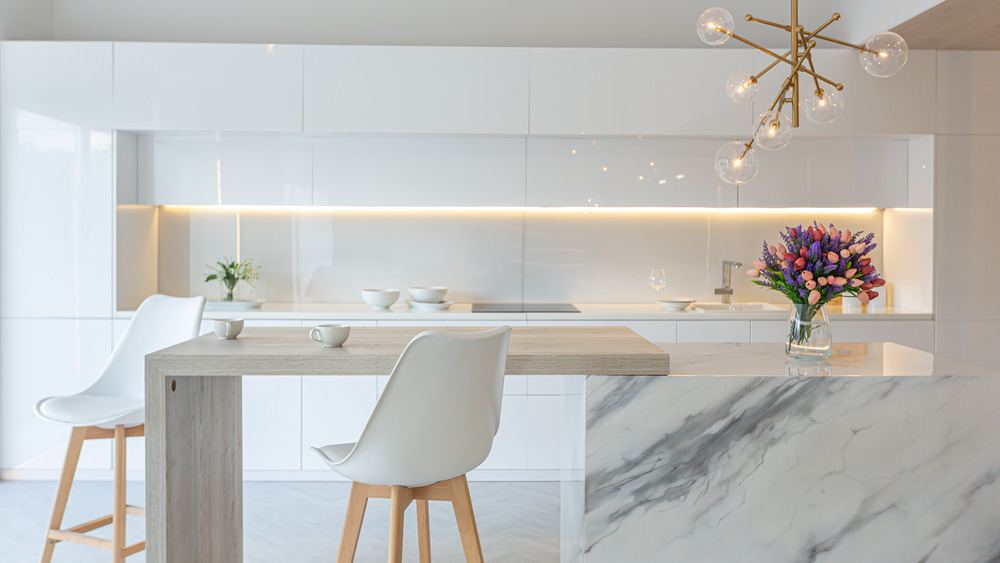 White kitchen with a marble island