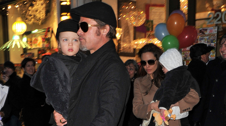 Brad Pitt carries Knox Jolie-Pitt as a baby