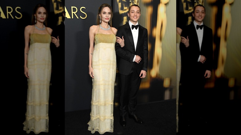 Knox walking on red carpet with Angelina Jolie at the Governor's Awards in Los Angeles