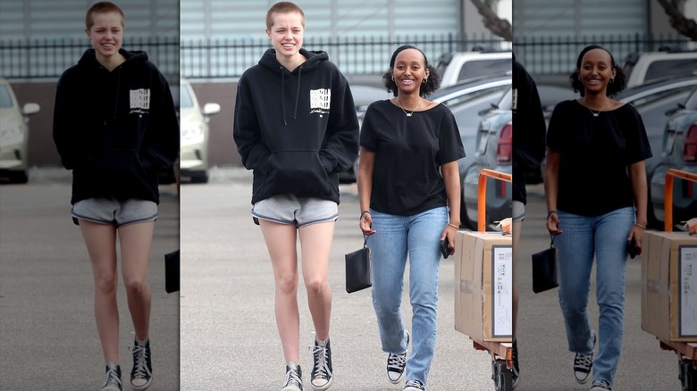 Shiloh Jolie-Pitt buzzcut walking with sister Zahara in parking lot