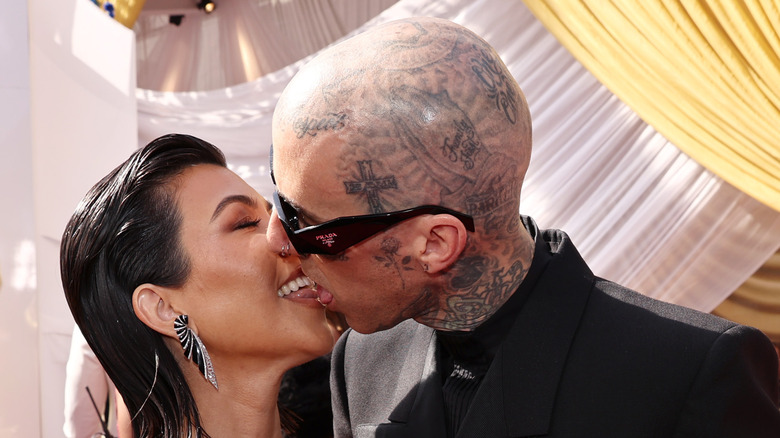 Kardashian and Barker kiss with tongue