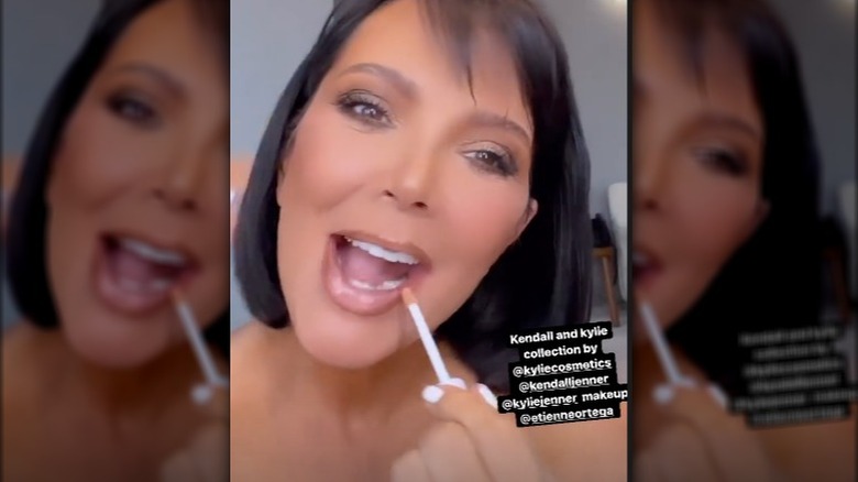 Kris Jenner applies lip gloss on Instagram