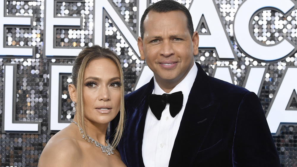 Jennifer Lopez and Alex Rodriguez in front of sparkly backdrop