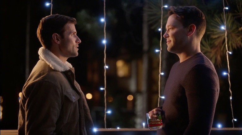 Kyle Dean Massey and Taylor Frey looking at each other in A Christmas to Treasure