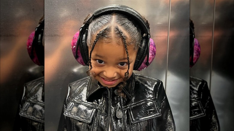 Stomi Webster wearing headphones smiling