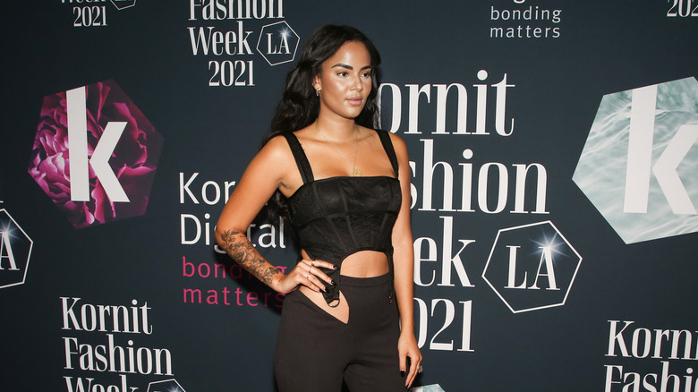 Kyra Green posing in black outfit at event 