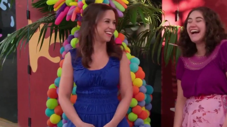 Lacey Chabert laughing in a blue dress