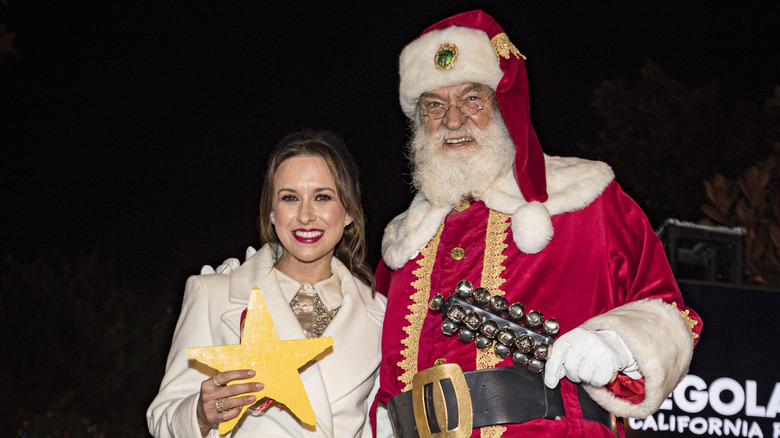 Lacey Chabert posing with Santa Claus