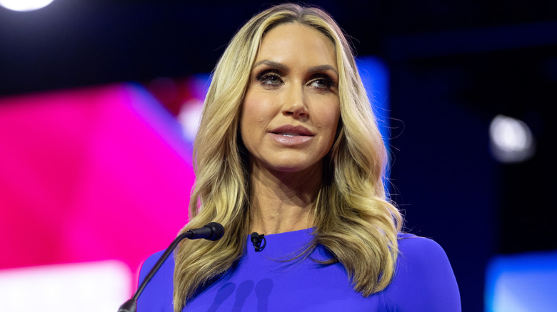 Lara Trump in a blue dressed photographed while speaking on stage