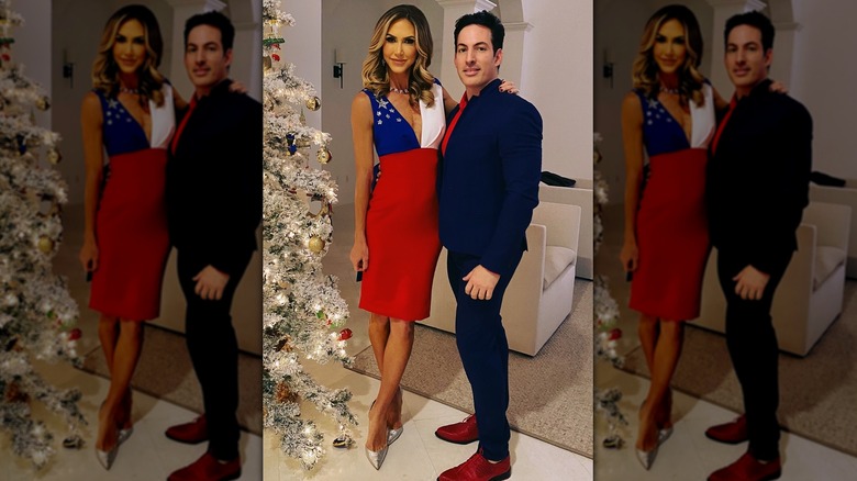 Lara Trump in American flag dress posing with Oscar Lopez next to Christmas tree