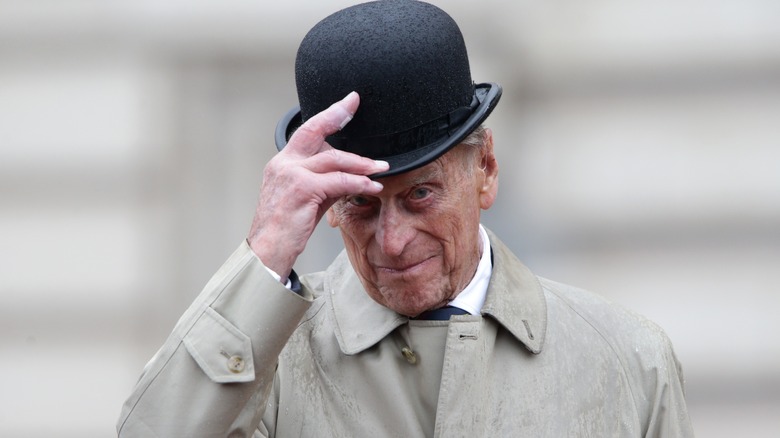 Prince Philip tipping his hat at the camera