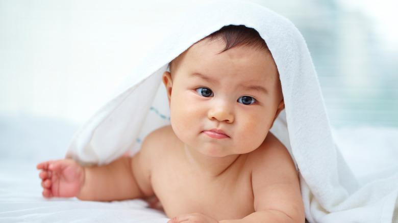 baby with towel on head