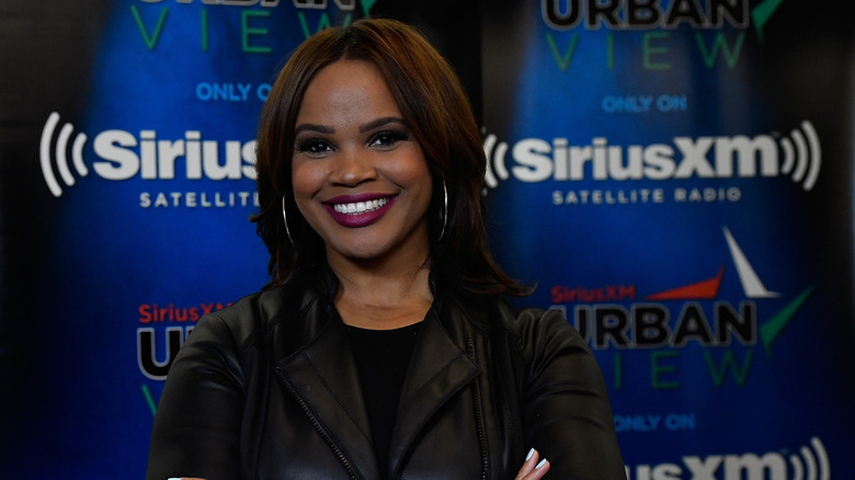 Laura Coates smiling and posing in Sirius XM studios