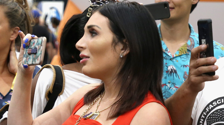 Laura Loomer holding camera