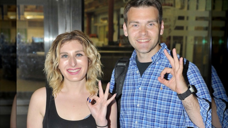 Laura Loomer and Jack Posobiec making the OK symbol with their hands