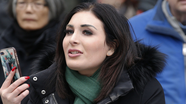 Laura Loomer stands across from the Women's March 2019