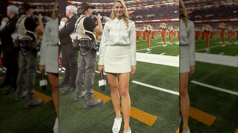 Laura Rutledge on sideline in white shirt and white skirt