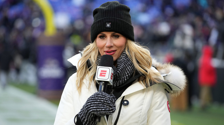 Laura Rutledge with microphone on sidelines