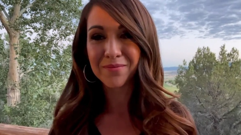 Lauren Boebert recording a video on her porch