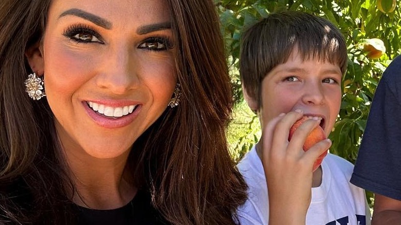 Lauren Boebert and her son Roman Boebert in a peach orchard