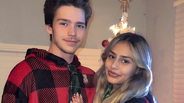 Tyler Boebert and his girlfriend pose in Christmas onesies