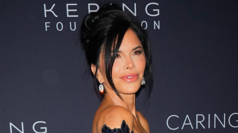 Lauren Sanchez walking the red carpet in a long lace gown