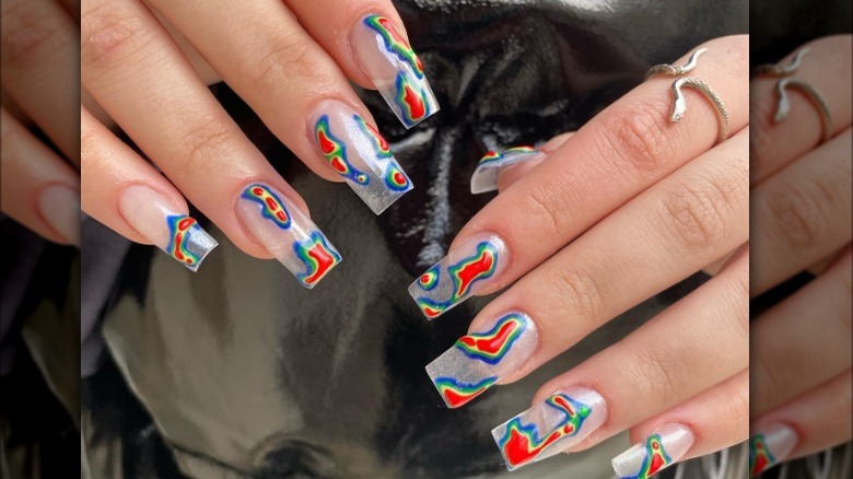 Two hands displaying colorful nail set