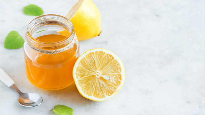 A jar of honey and cut up lemon