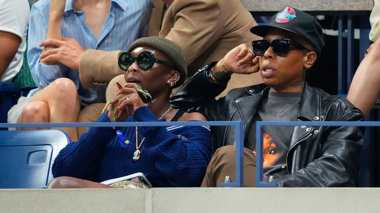 Cynthia Erivo and Lena Waithe sit together at a sports game