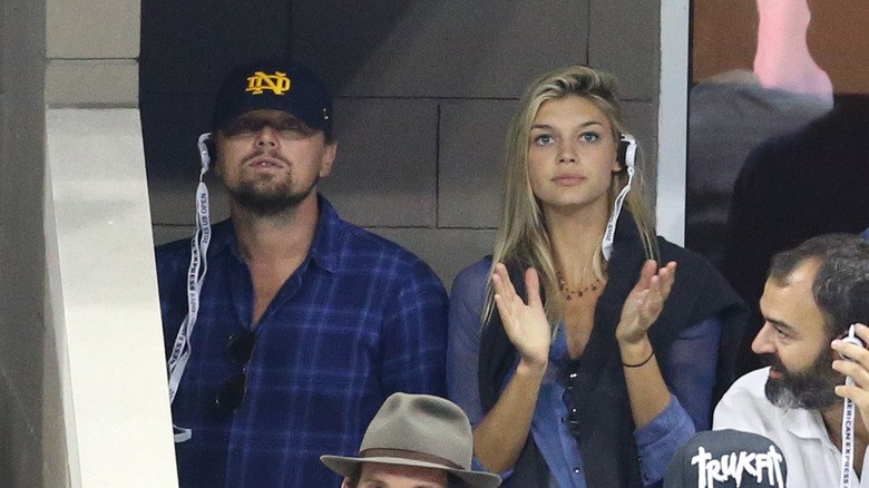 Leonardo DiCaprio and Kelly Rohrbach watching a game