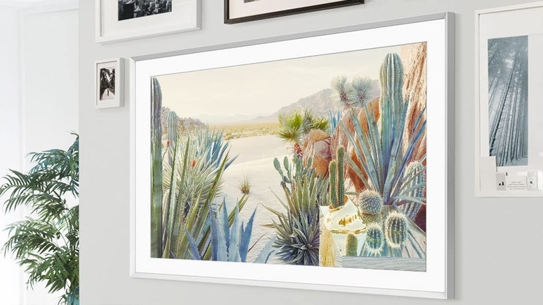 Samsung The Frame TV on a white wall and a cactus painting