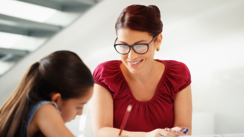 A mom with her daughter doing homework