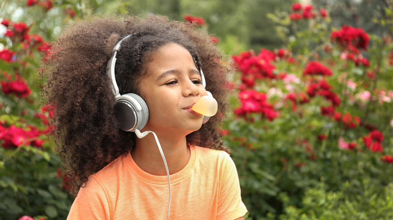 A young girl chewing gum