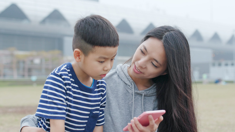 A mother and her son with a phone