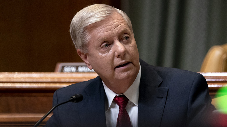 Graham in blue suit, red tie