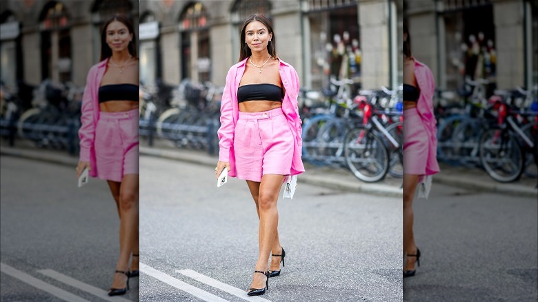 Woman wearing pink linen shorts and shirt