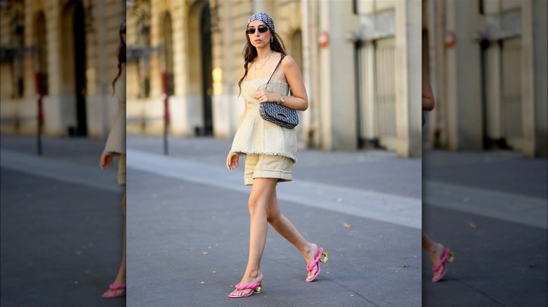 Woman wearing linen peplum top and shorts