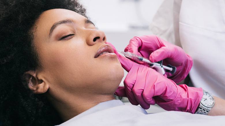 woman having botox done on lip