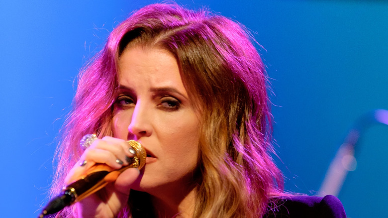 Lisa Marie Presley performing a song on stage in 2012 