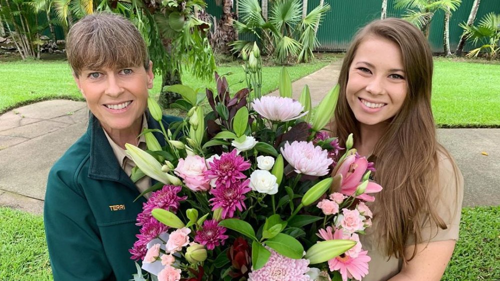 Terri and Bindi Irwin holding flowers