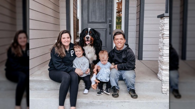 Tori and Zach Roloff with kids and dog on doorstep