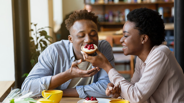 Black couple feeding each other sweets