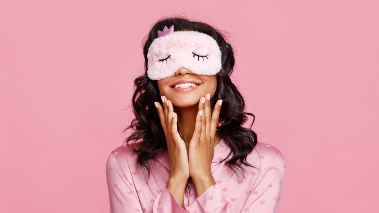 Woman in pajamas with pink background