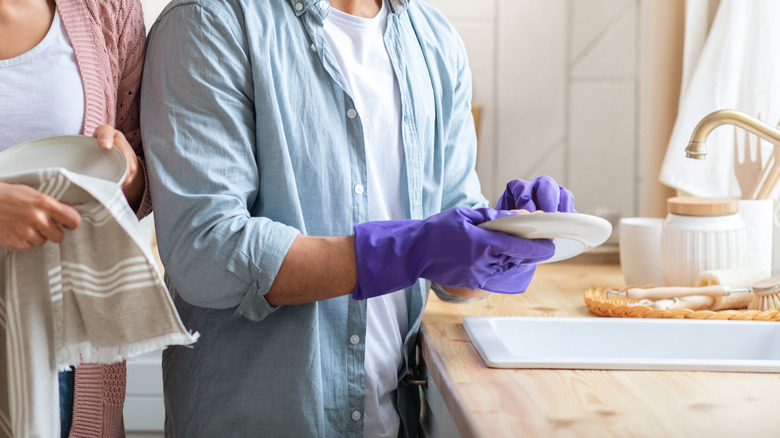 couple washing dishes together