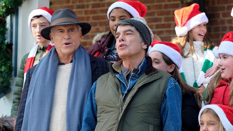 Bruce Campbell and Peter Gallagher with carolers in "One December Night"