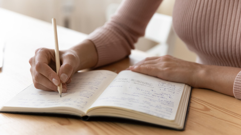 woman writing in notebook