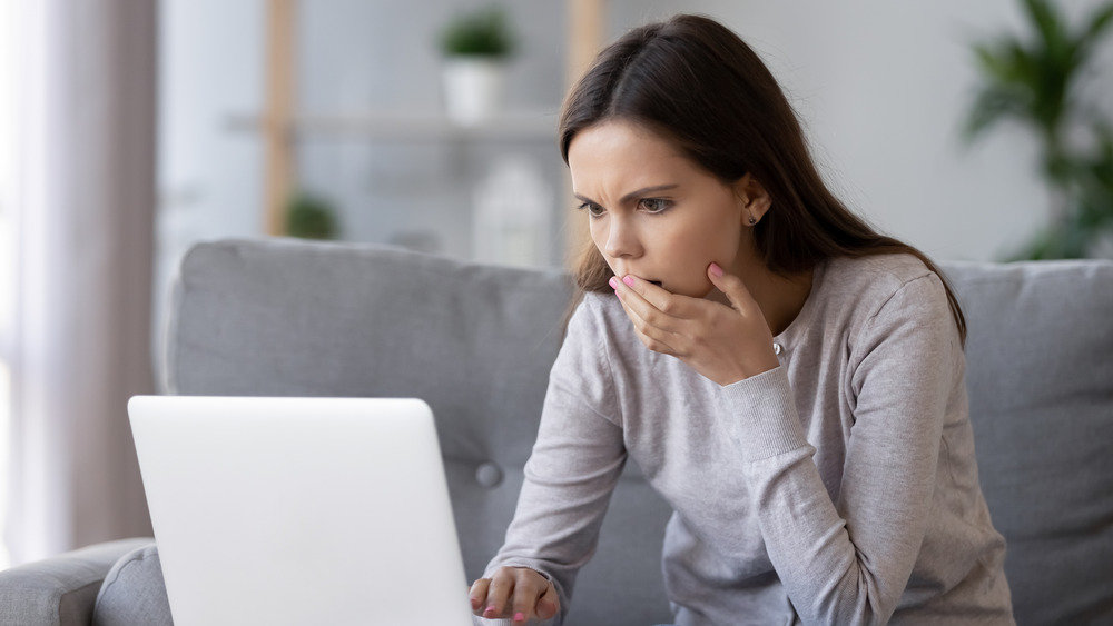 Woman looking worried at computer