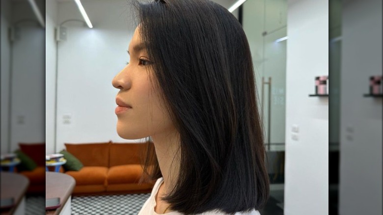 Side profile of woman with straight shoulder length hair