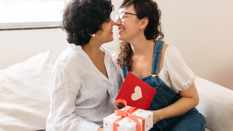 Queer couple exchanging gifts